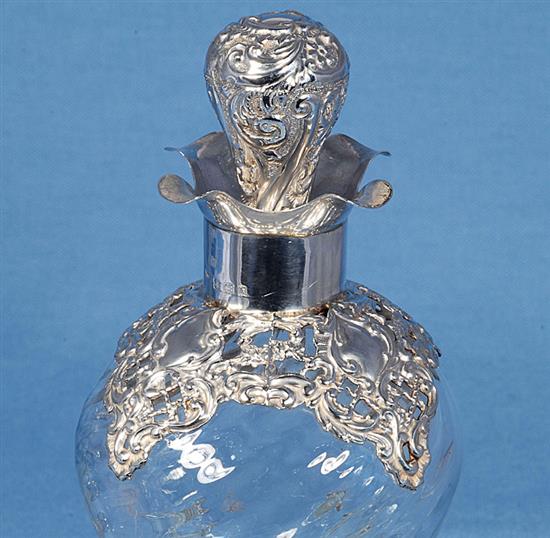 A pair of Edwardian silver mounted waisted glass decanter and stoppers,